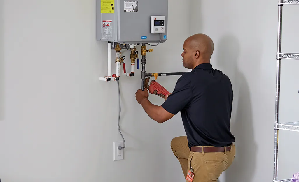 Tankless Water Heater Emergency In Pottstown, PA 1 Man replacing or installing tankless water heater.
