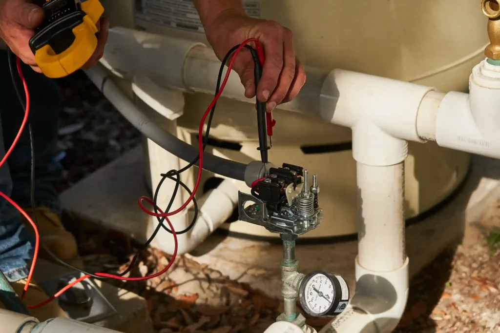 Well Pump Services in Coatesville, PA 1 Technician testing electrical connections on a water heater.